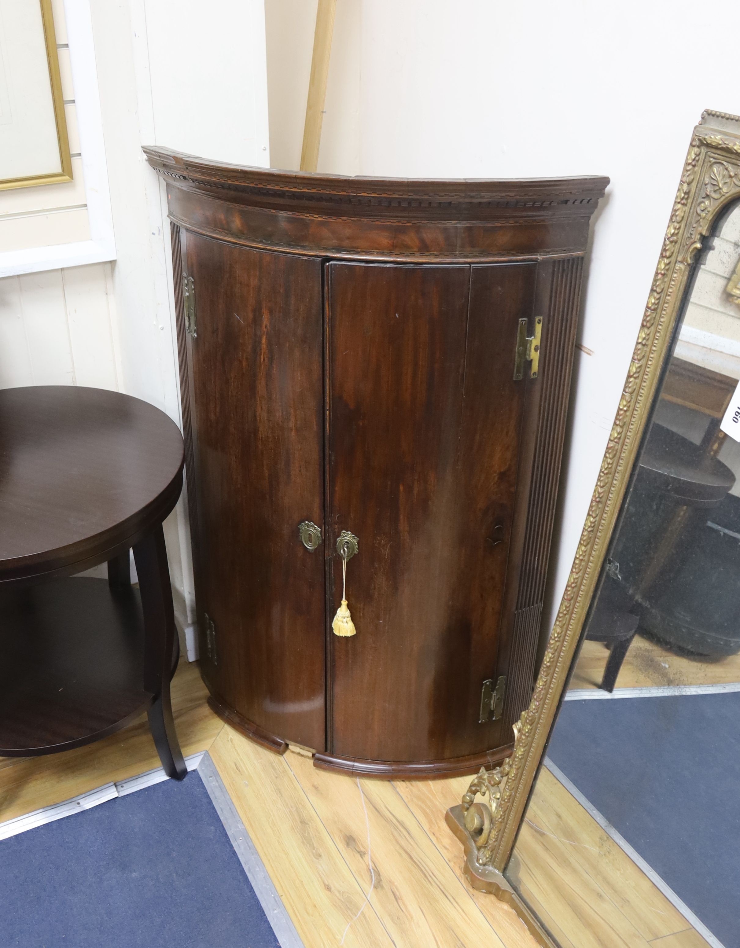 A George III banded mahogany bow front hanging corner cabinet, width 76cm, depth 53cm, height 113cm